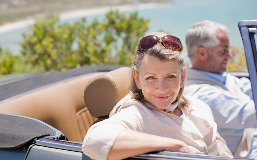 People riding in a convertible.