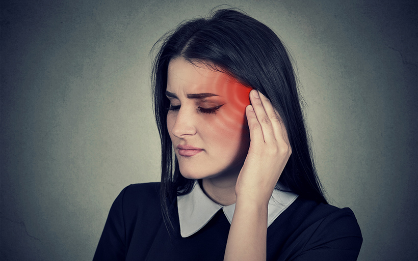 Woman holding her ear in pain