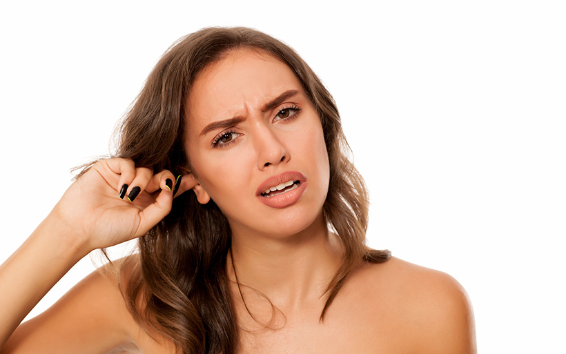 Woman with finger in her ear