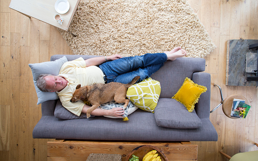 Picture of a guy lying on the couch.