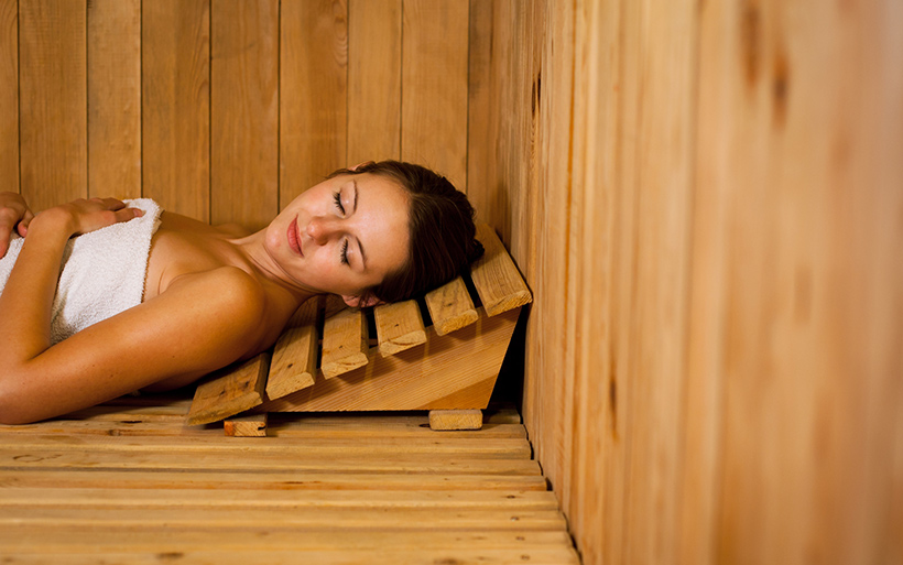Picture of a woman lying down in a sauna