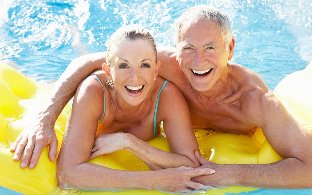 Senior couple swimming in a pool