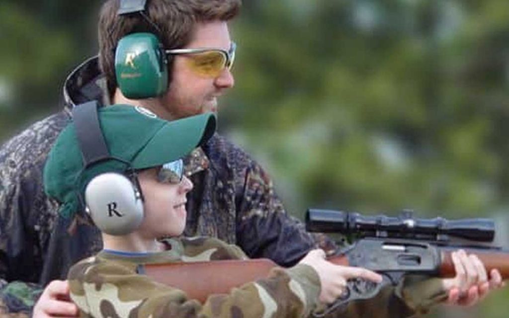 Father and son using ear protection to hunt.