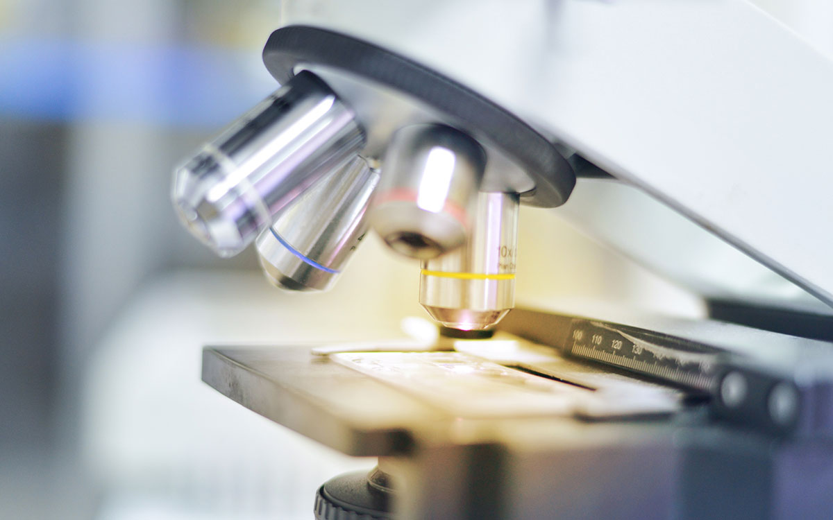 Woman with hand up to her ear. Regrowing hair and hearing loss.