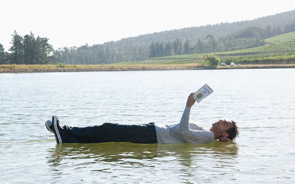 Man appearing to float on water. Misconception of Tinnitus.