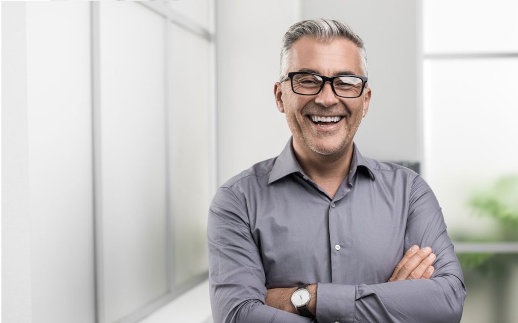 Happy middle aged man feeling better through tinnitus treatment.