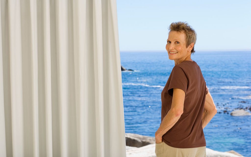 Woman underatnding the truth behind hearing aids behind a cutain.