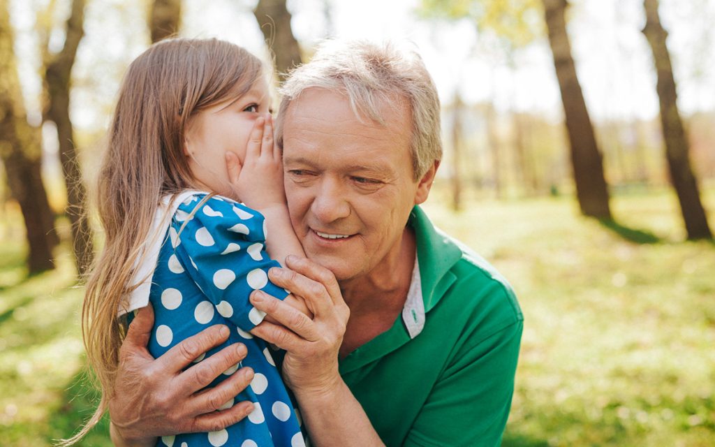 Grandfather suffering from unilateral hearing loss and struggling to hear his granddaughter.