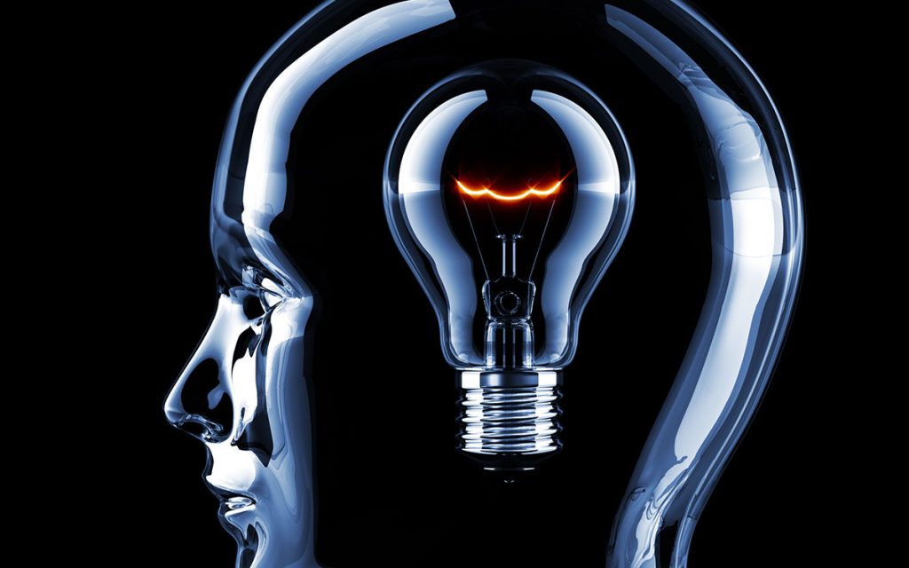 Head with lightbulb representing training your ear.