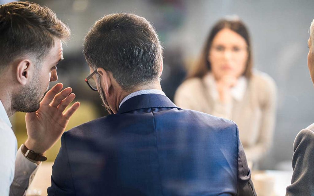 Person whispering a myth about Tinnitus.