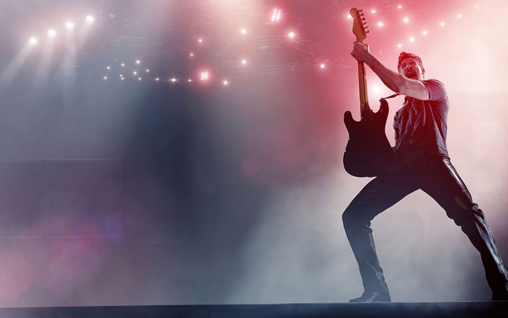 Musician on stage suffering from hearing loss.