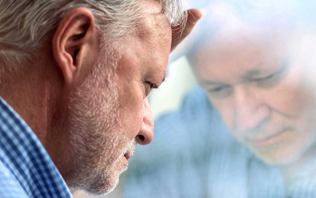 Man suffering from depression because of hearing loss.