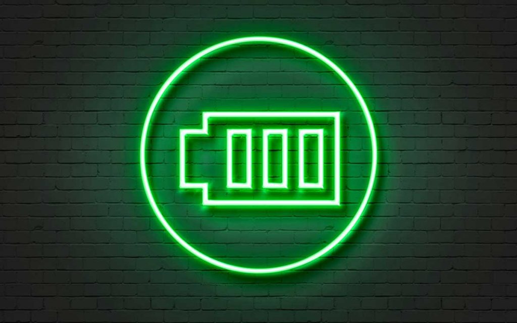 Neon sign of green rechargeable hearing aid batteries.