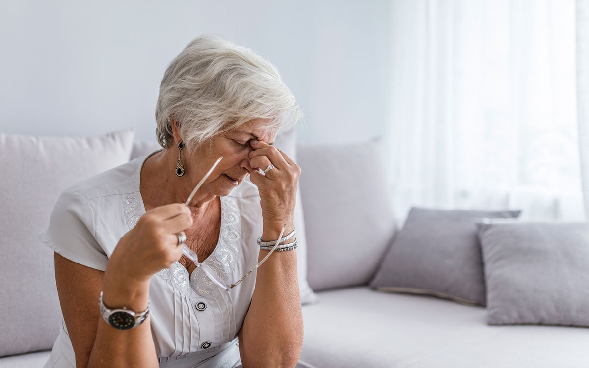 Woman feeling very tired and fatigued because of hearing loss.