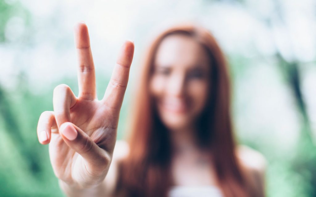 Deaf woman showing sign language.