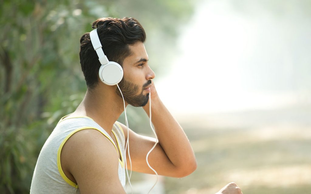 Twenty year old that is wearing headphones and suffering from hearing loss.