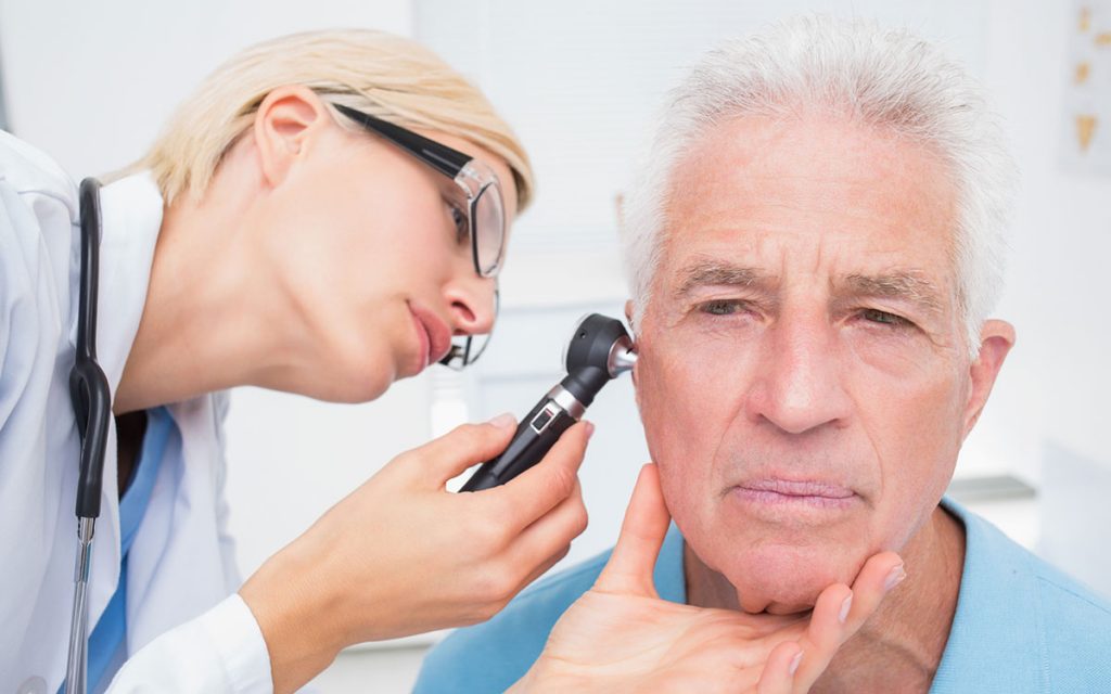 Man getting a checkup after getting hearing aids.