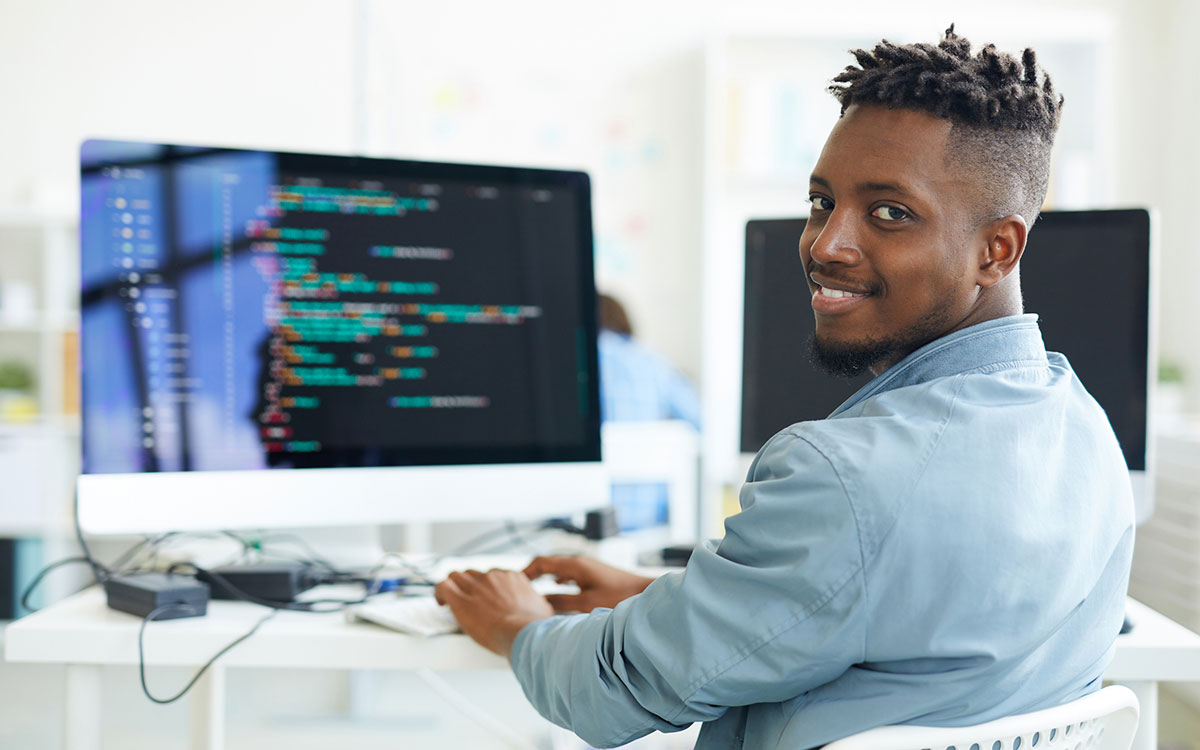 Man working at computer on innovations to help people with hearing loss.