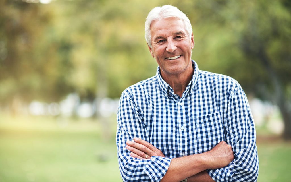 Happy middle aged man living with Tinnitus