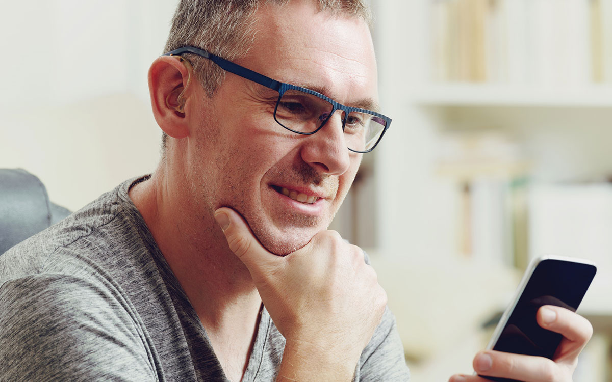 Hearing impaired man using technology to help.