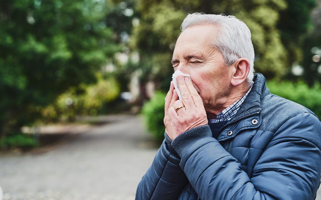 Man suffering from a sinus infection and hearing loss.