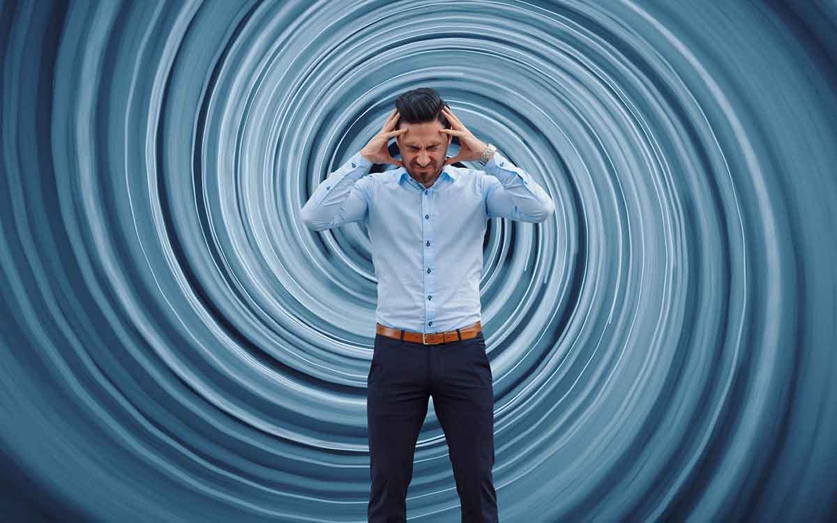 Man with dizzy swirl behind him suffering from hearing loss.