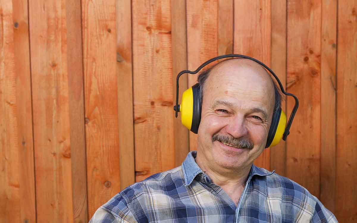 Man using hearing protection and hearing aids.