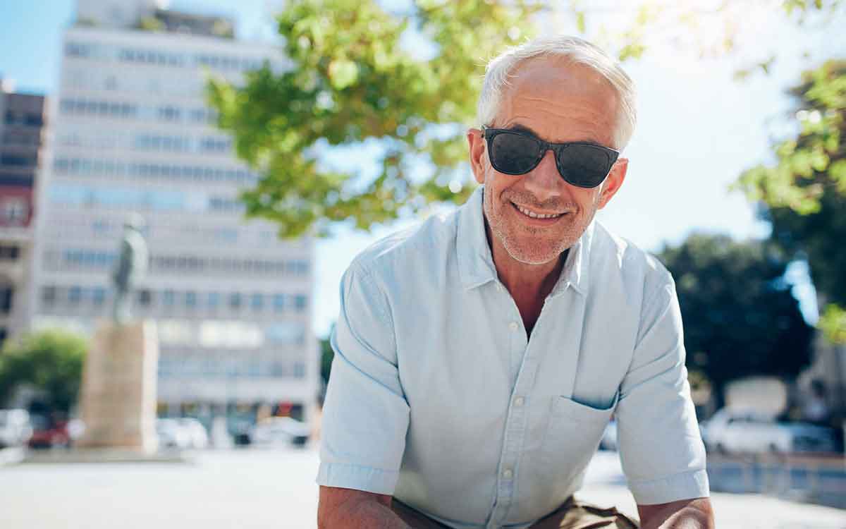 Senior man with sunglasses on. Hearing aids are cool.