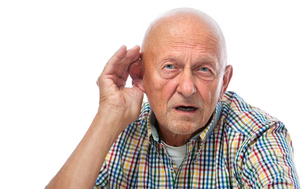 Man with hand to his ear with dangerous untreated hearing loss.
