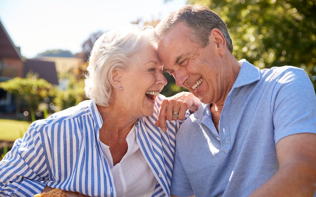 Happy senior couple seeing a hearing specialist.