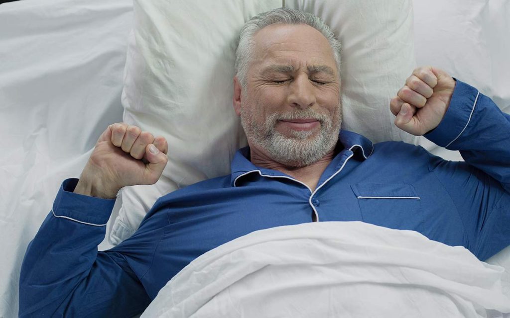 Man who's had a good night sleep because of hearing aids.