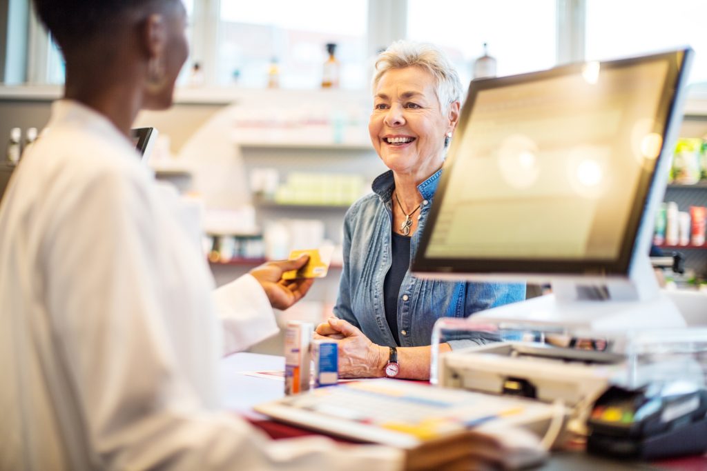 Woman purchasing over the counter hearing aids.