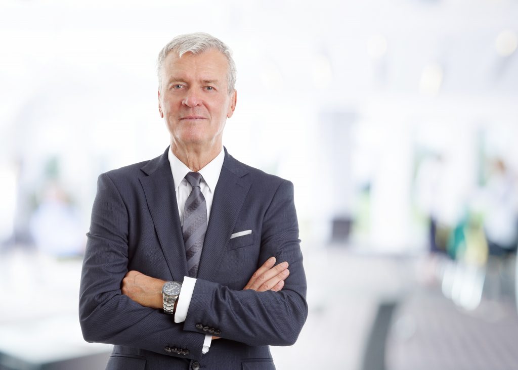 Businessman wearing hearing aids to help his career.