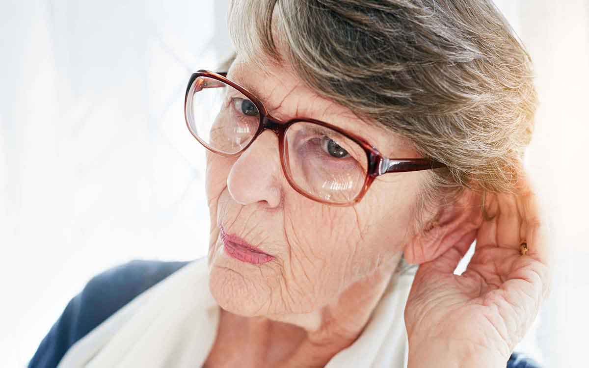 Woman who is sufering from the first signs of age related hearing loss.