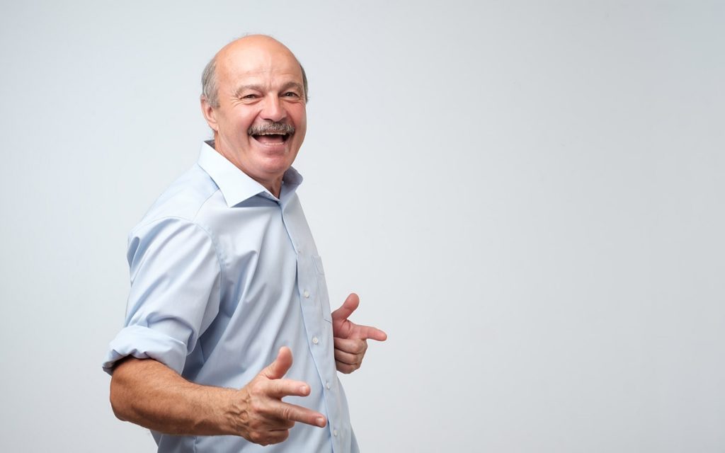 Happy senior man who has the the best hearing aids.