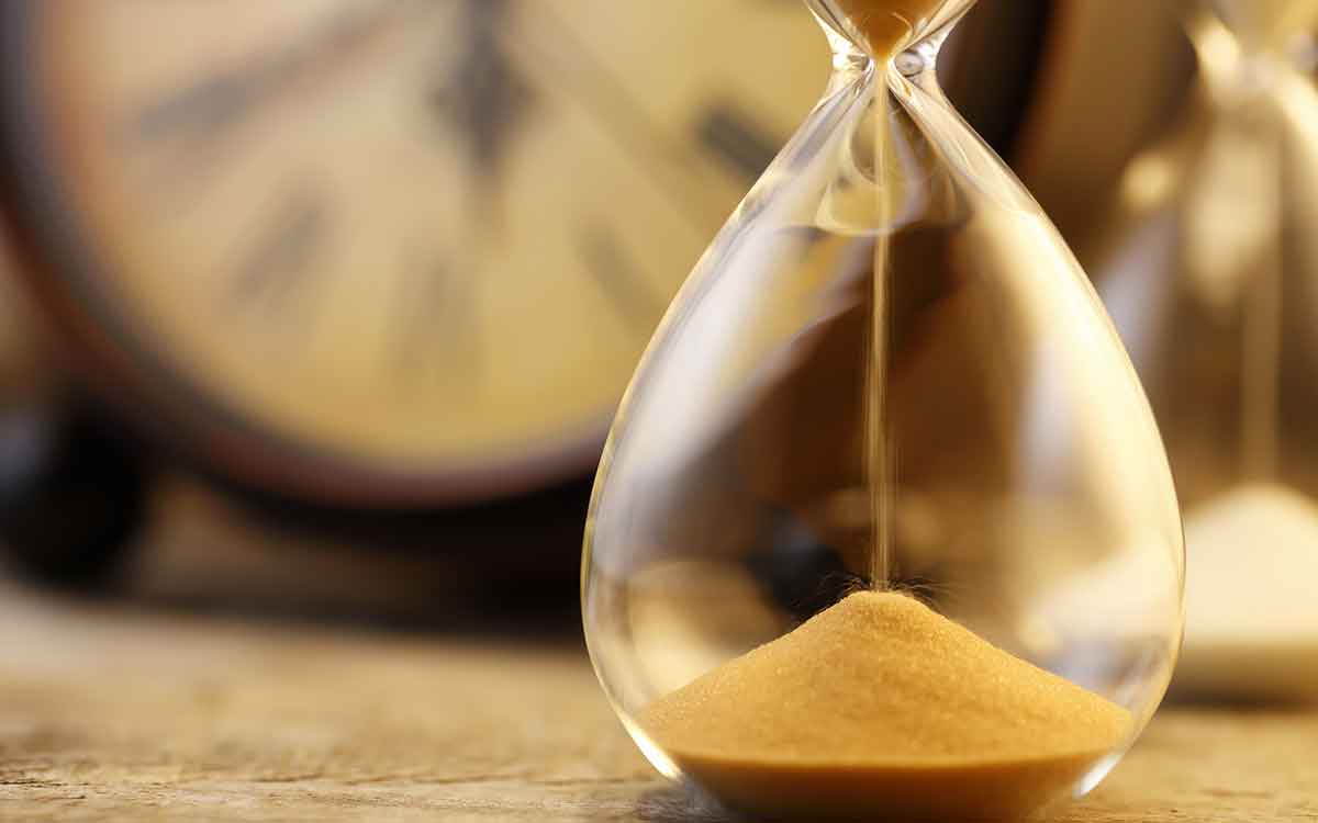 Hourglass with sand emptying representing the passing of time.