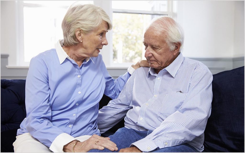 Senior couple talking about hearing loss and hearing aids.