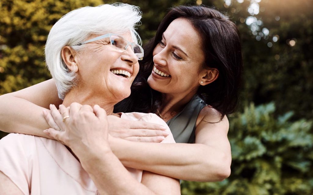 Shot of a happy senior woman spending quality time with her daughter and caring for her hearing loss.
