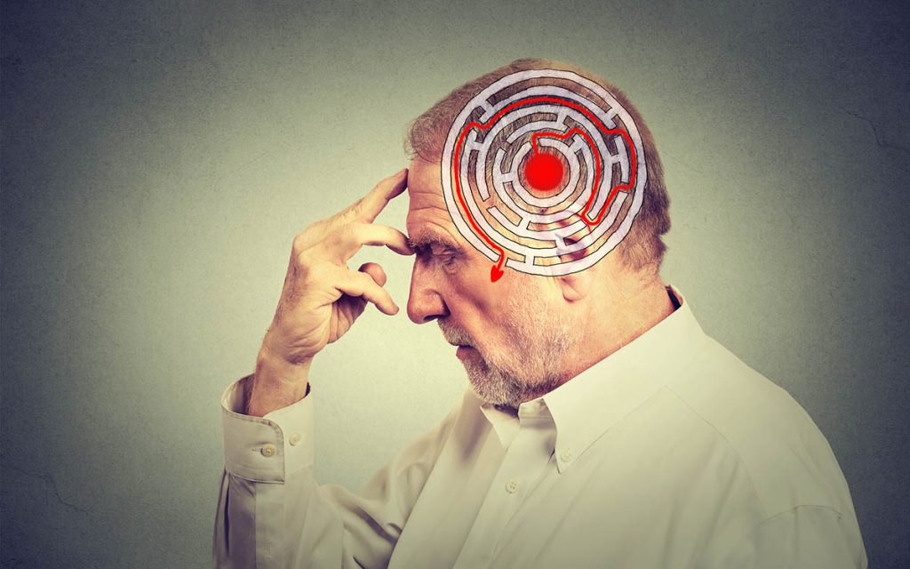 Side profile elderly man thinking about problems with great mental acuity from wearing hearing aids.