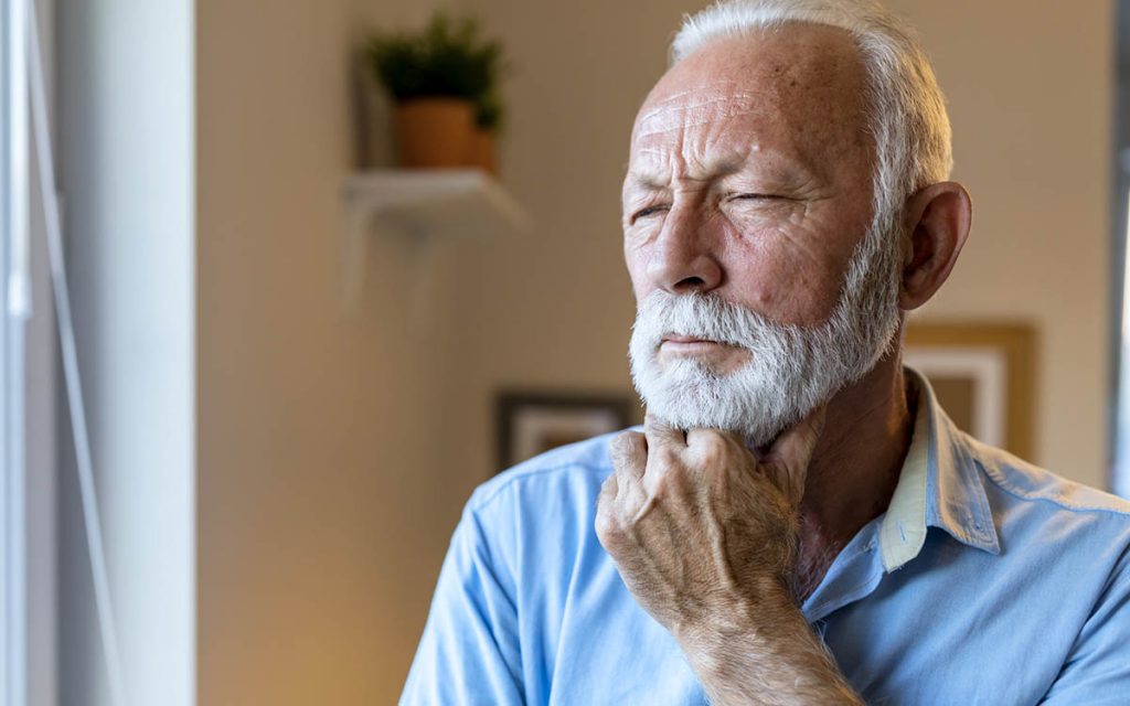 Concerned senior man who can't decide on types of hearing aids.