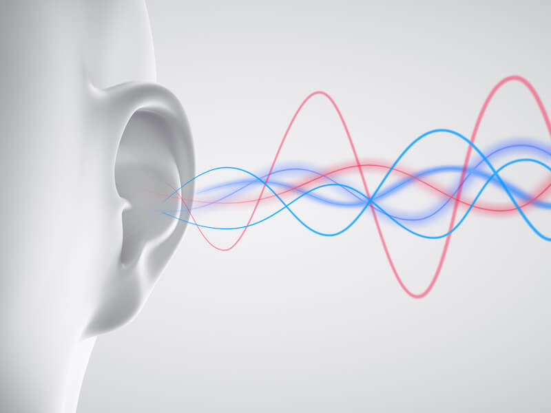 Ear with sound waves on light background simulating a hearing test