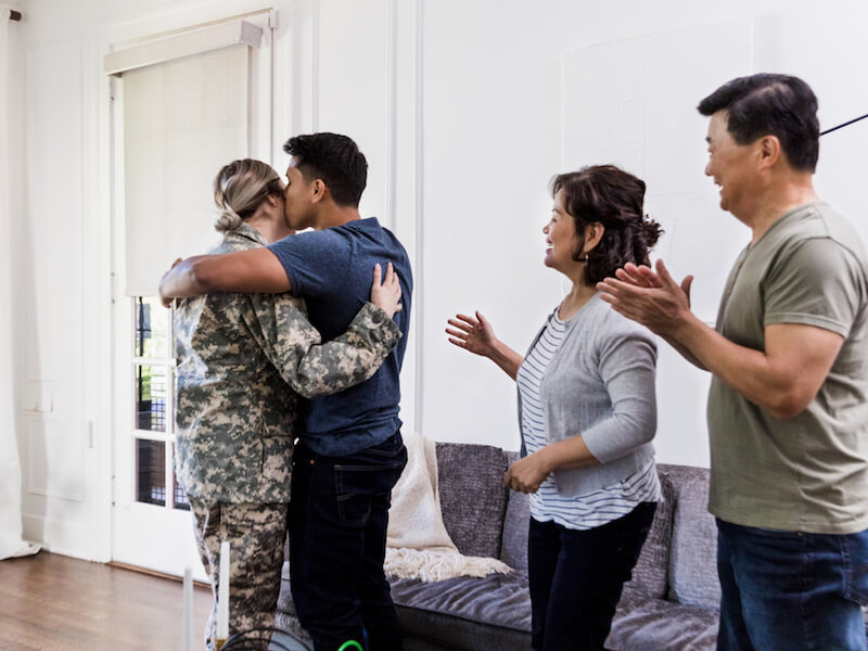 Veteran woman with hearing loss returns home from military service and greets her family.