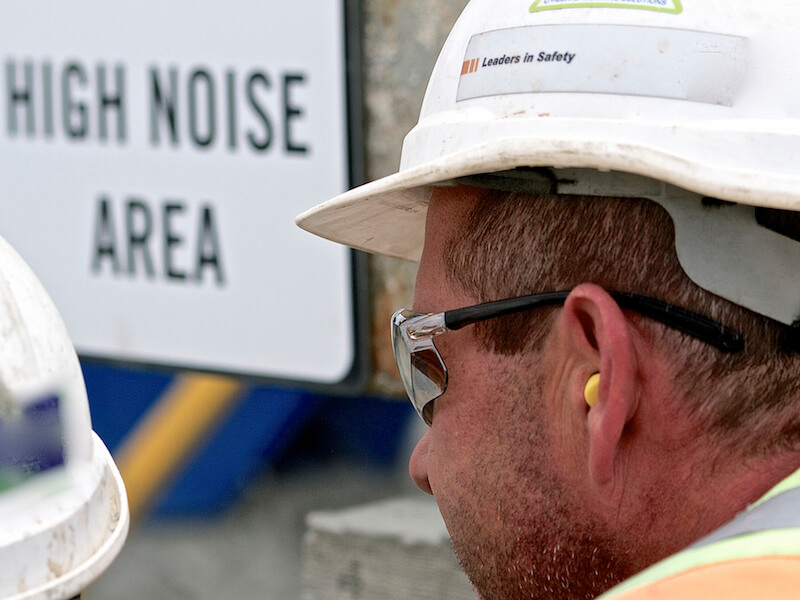 Man wearing hearing protection in a high noise area at work.