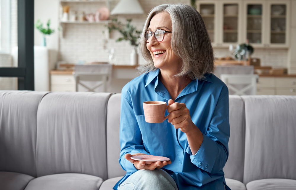 woman sitting at home relaxing with a cup of coffee.