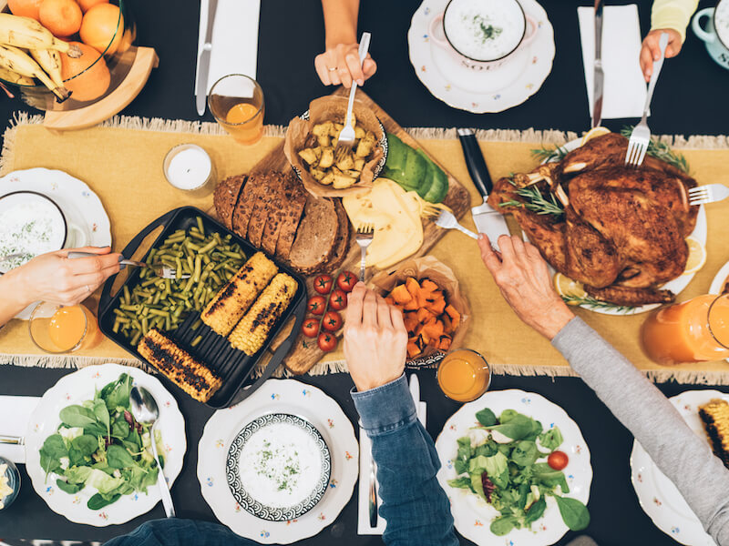 Family gathered at a holiday meal and making a lot of noise.