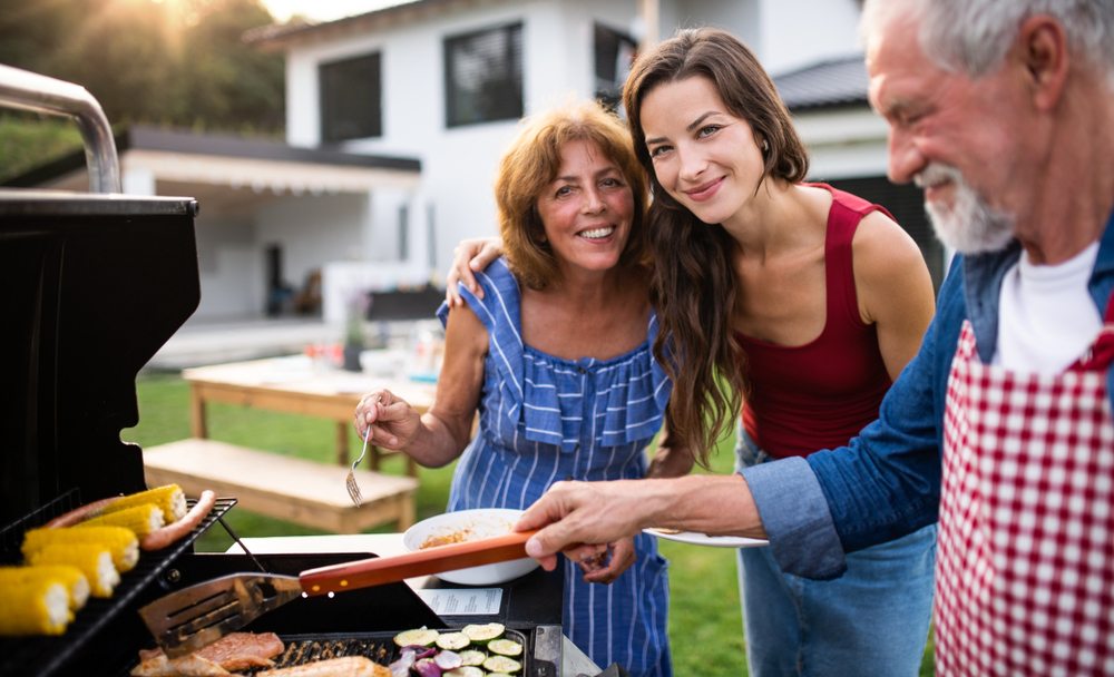 Family grilling outside during summer.
