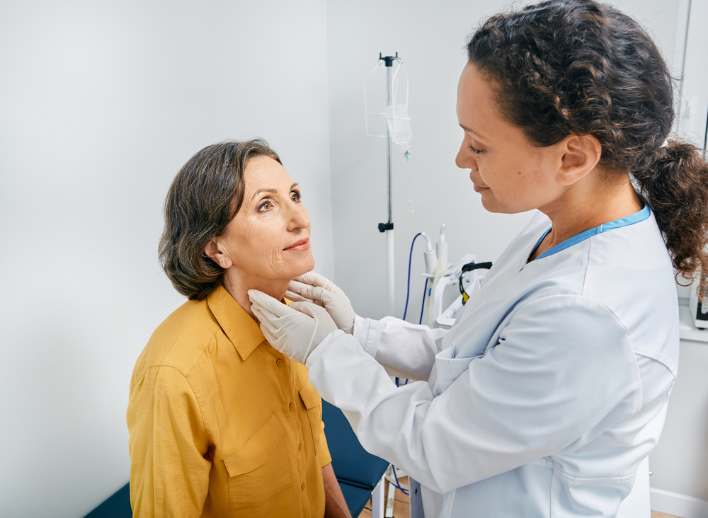 ENT specialist evaluating patient's thyroid.