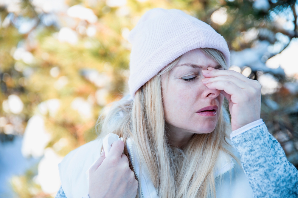 woman with winter allergies outside.