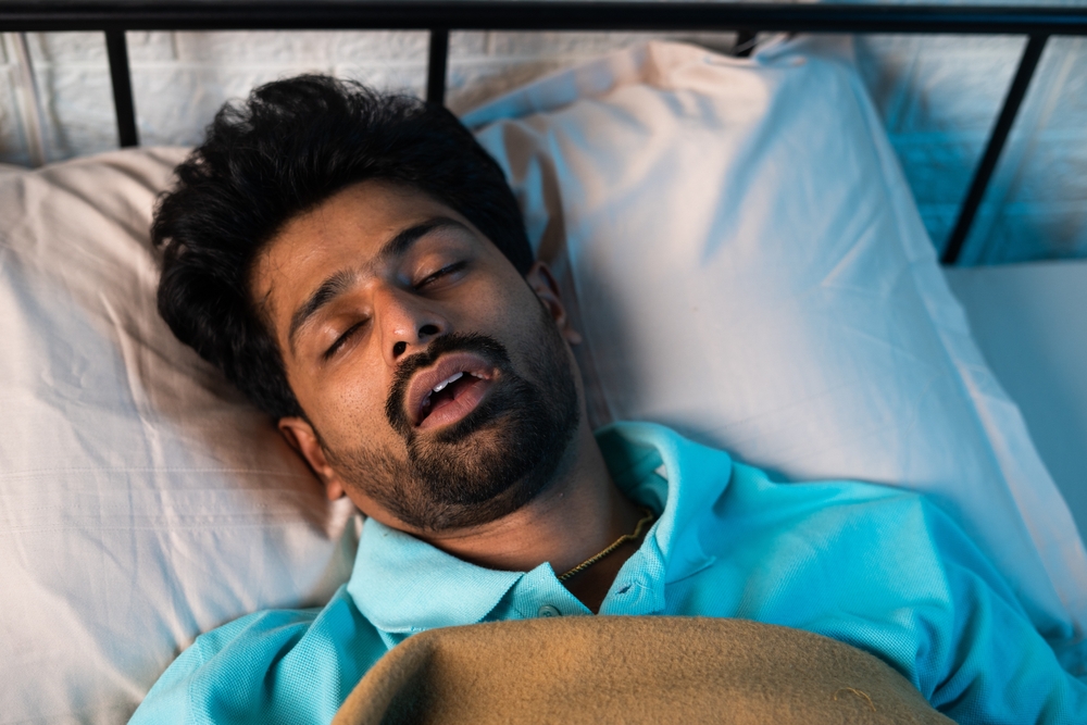 man sleeping with untreated sleep apnea.