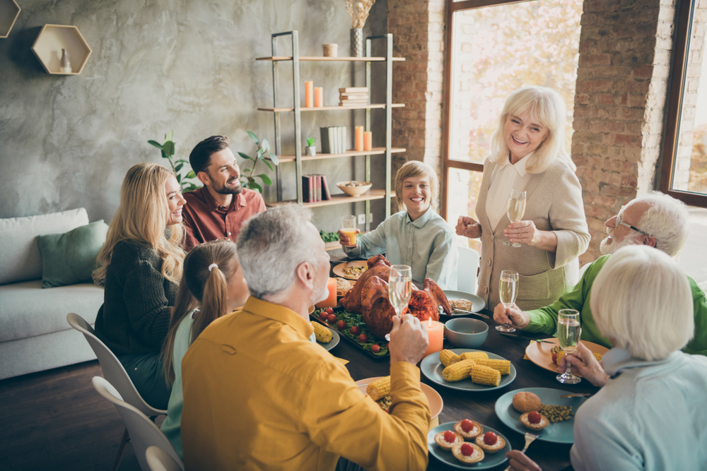 Family sitting at table for Thanksgiving dinner.
